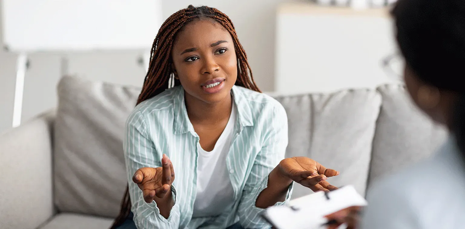 A patient talking with a mental health provider during a telehealth-style session