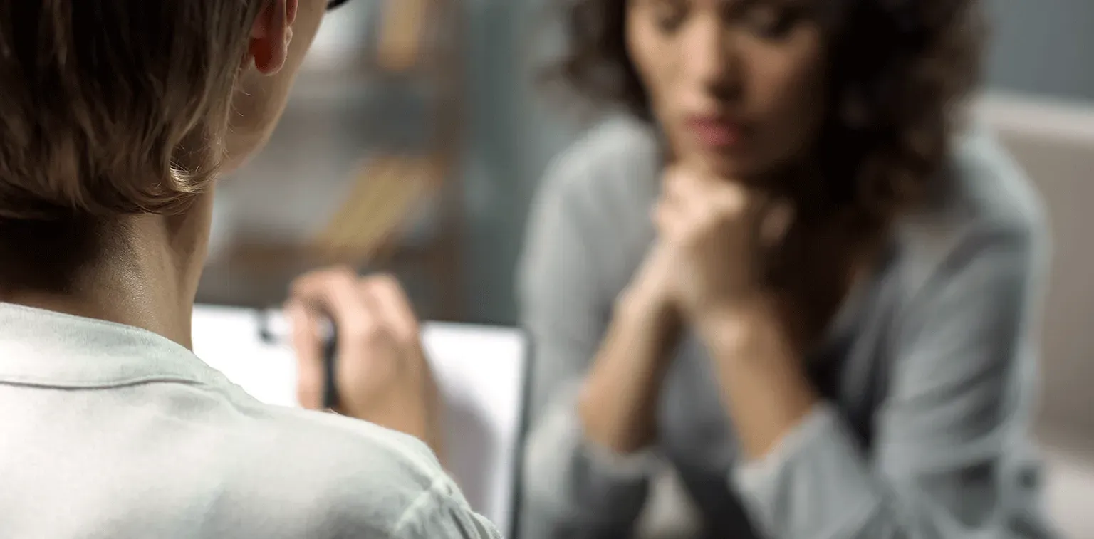 A provider listening attentively to a patient during a therapy session