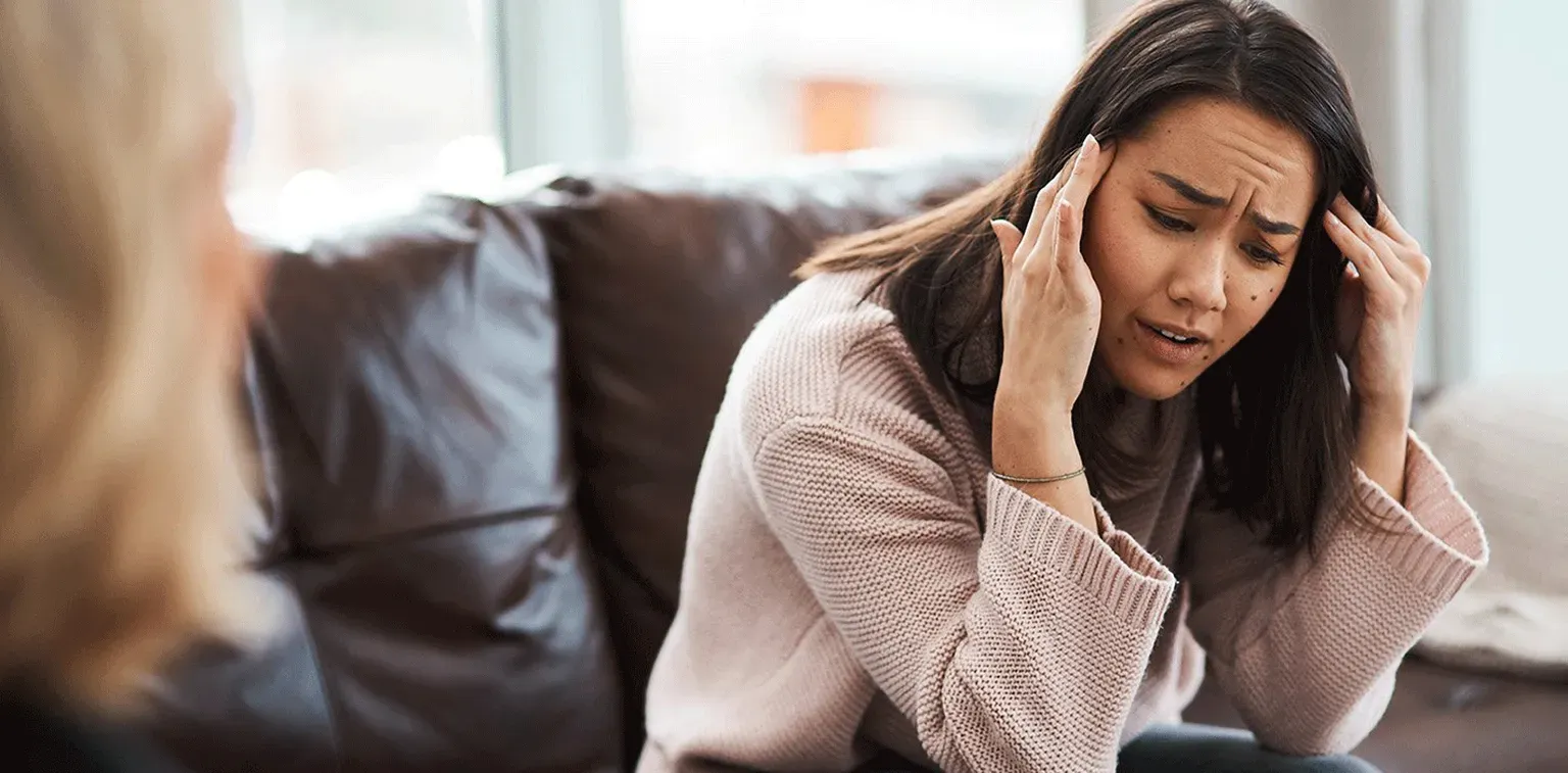 A woman speaking with a mental health provider during a supportive session